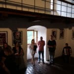 Žiaci stojaci v Citadele Oravského hradu na vernisáži ich diel - fotografia.